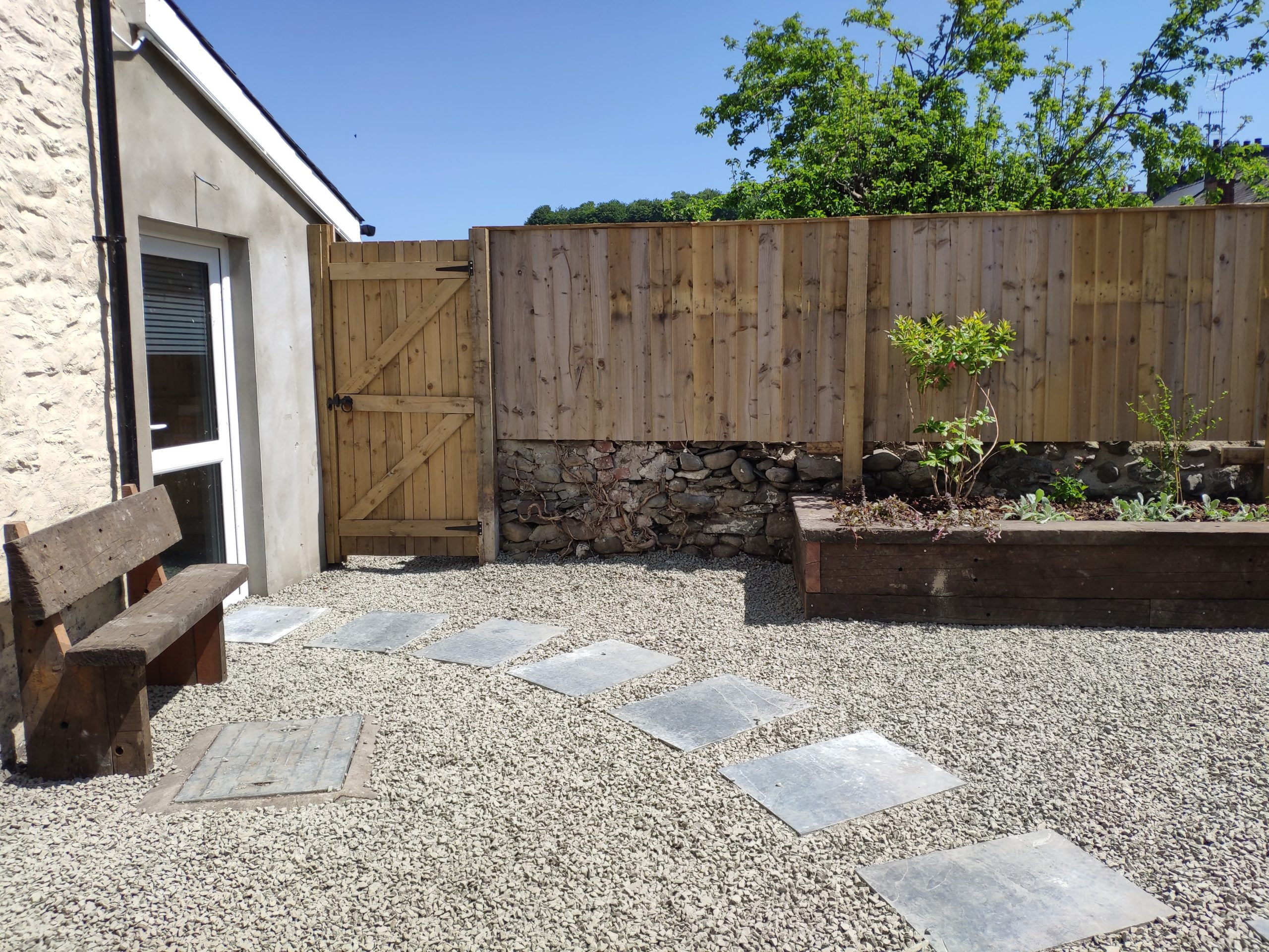 The transformed rear garden at Pont Steffan Dental with new fencing and raised beds